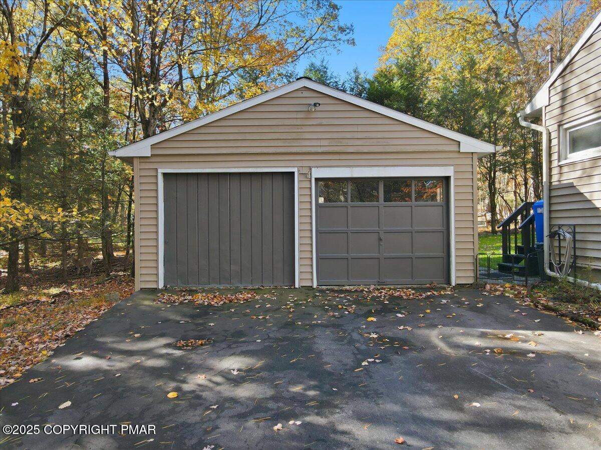 612 Prices Drive Cresco, PA 18326 - Photo 4 of 37 a front view of a house with a yard and garage