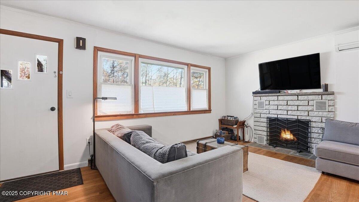 612 Prices Drive Cresco, PA 18326 - Photo 7 of 37 a living room with furniture a flat screen tv and a fireplace