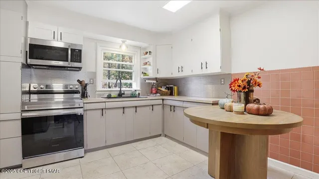 a kitchen with stainless steel appliances a refrigerator stove and microwave