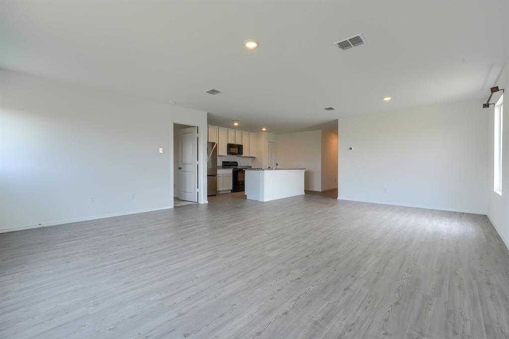 5916 Crystal Water Way Princeton, TX 75407 - Photo 13 of 28 a view of a kitchen with a dishwasher and a refrigerator
