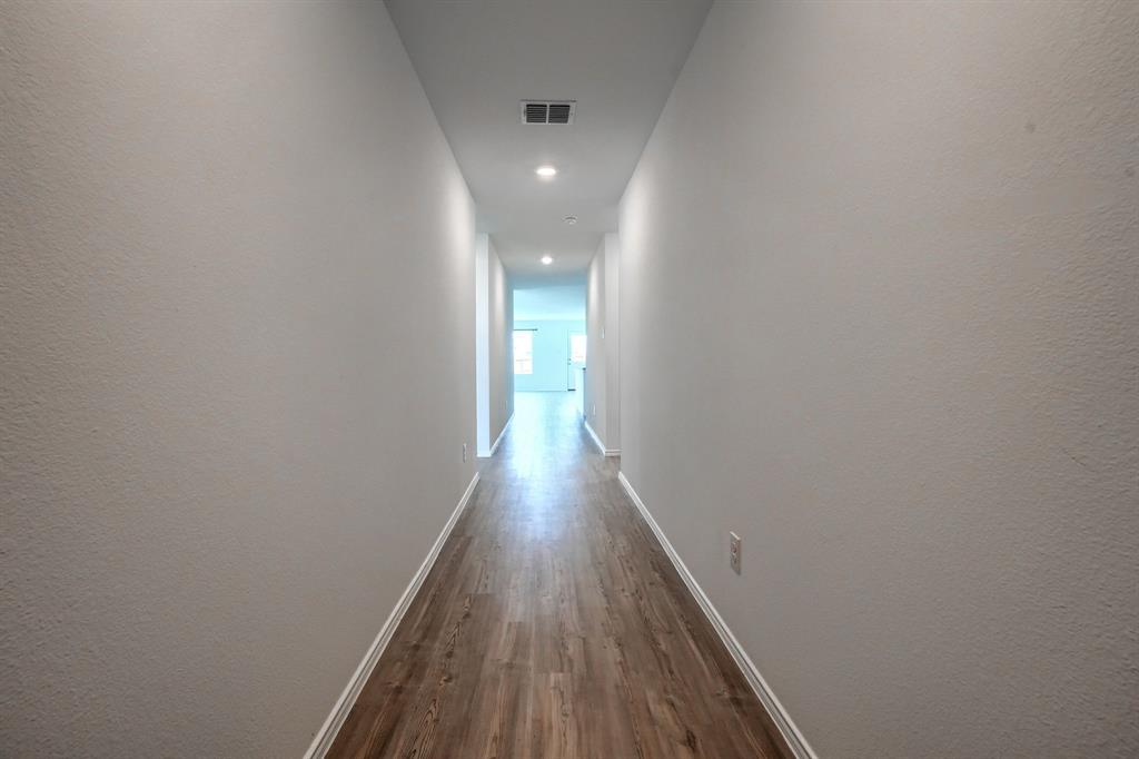 5916 Crystal Water Way Princeton, TX 75407 - Photo 3 of 28 a view of a hallway with wooden floor