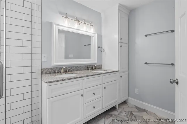 a bathroom with a granite countertop sink mirror and double