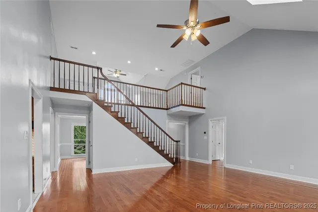 a view of staircase with wooden floor and a chandelier