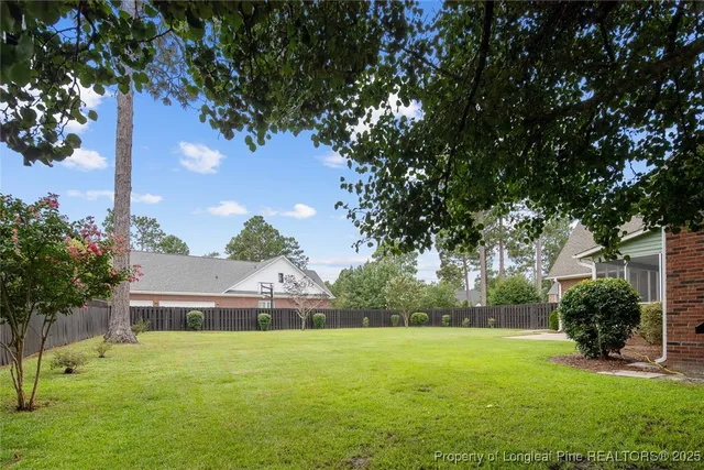 a view of backyard of house with green space