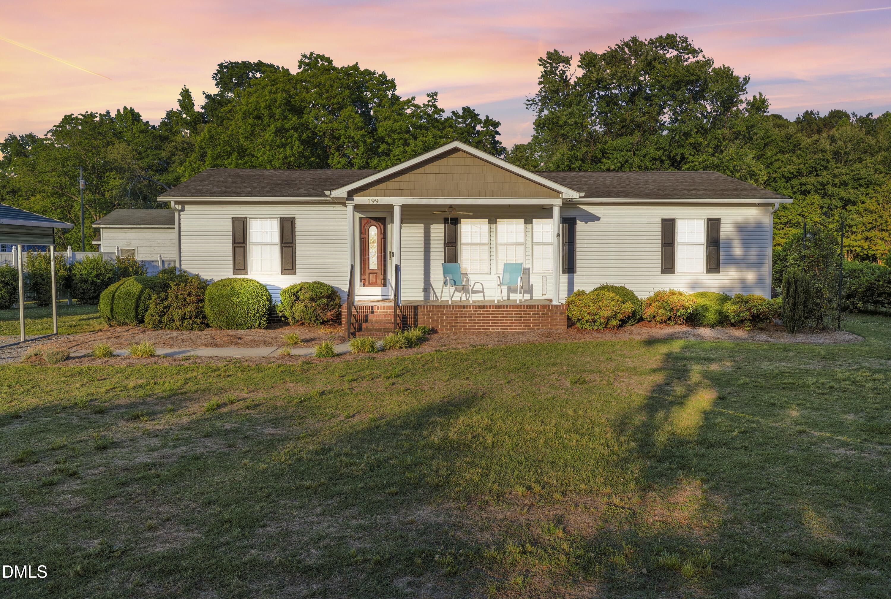 199 Iris Bryant Road Erwin, NC 28339 - Photo 1 of 33 a front view of a house with garden