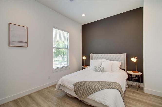 2309 Eagle Street Houston, TX 77004 - Photo 11 of 34 a bedroom with a bed and wooden floor