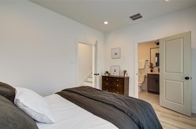 2309 Eagle Street Houston, TX 77004 - Photo 13 of 34 a bedroom with a bed and a dresser