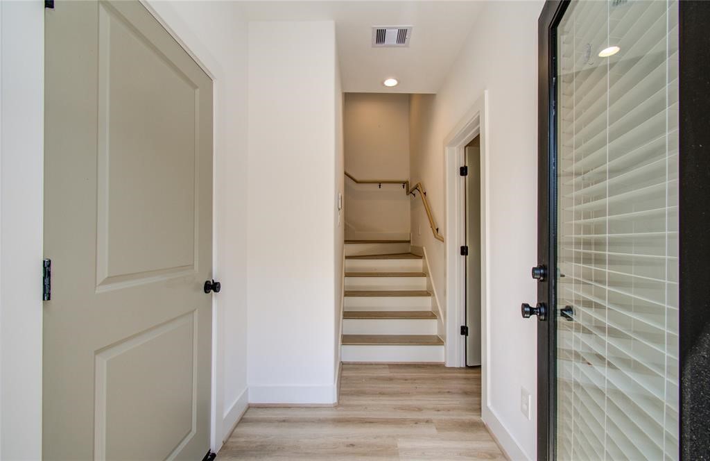 2309 Eagle Street Houston, TX 77004 - Photo 19 of 34 a view of a hallway with wooden floor and staircase