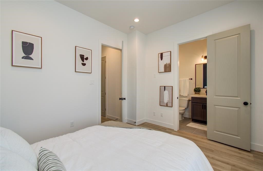 2309 Eagle Street Houston, TX 77004 - Photo 10 of 34 a bedroom with a bed and a refrigerator