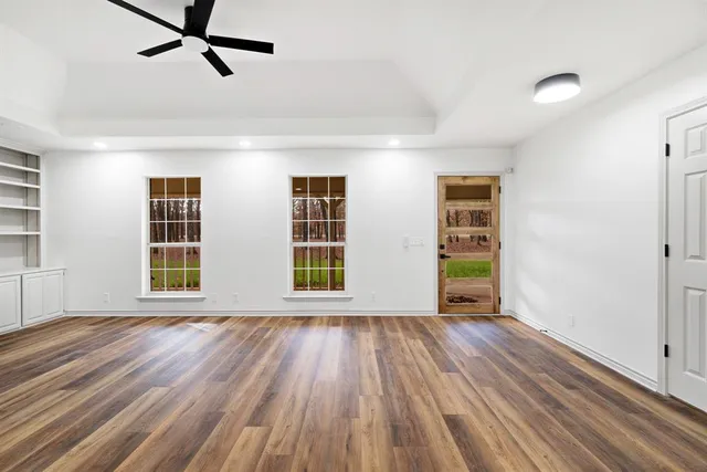 wooden floor in an empty room with a window