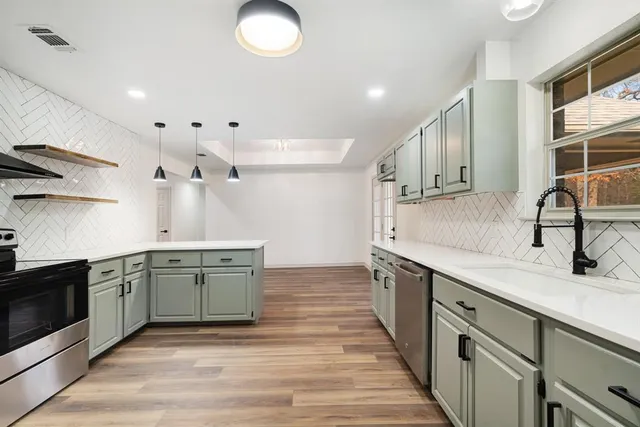 a kitchen with a sink and cabinets