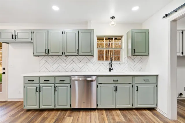 a kitchen with stainless steel appliances granite countertop a sink and cabinets