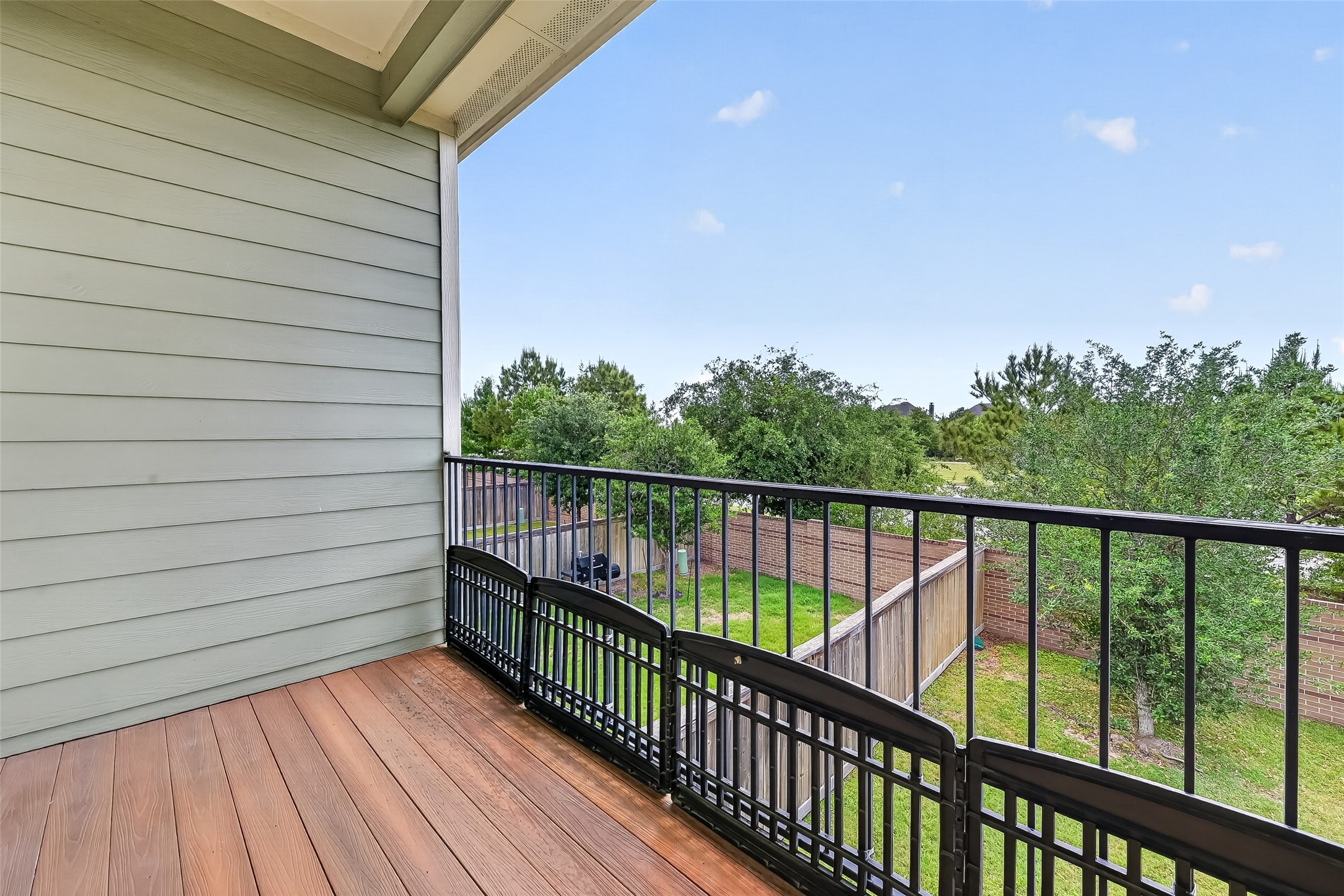 16226 Rattlesnake Run Trail Cypress, TX 77433 - Photo 13 of 29 a balcony with wooden floor and fence