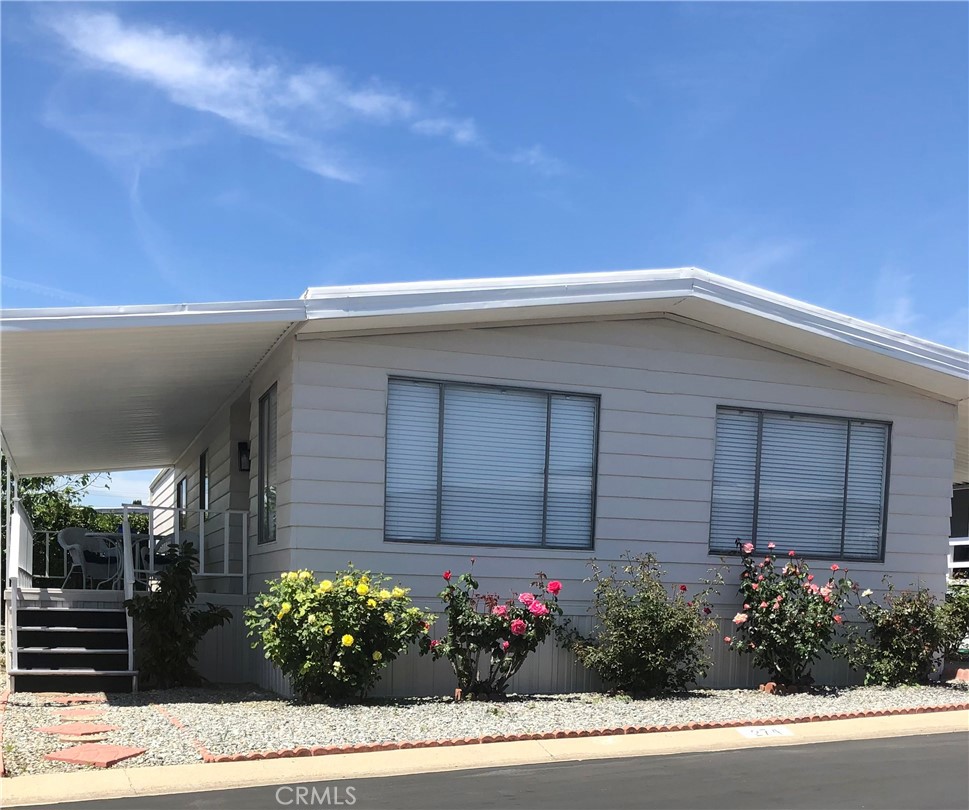 10210 Base Line Road Rancho Cucamonga, CA 91701 - Photo 2 of 13 a house with a flower garden in front of it