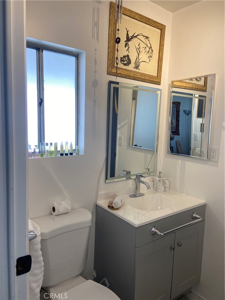 10210 Base Line Road Rancho Cucamonga, CA 91701 - Photo 7 of 13 a bathroom with a sink vanity mirror and toilet