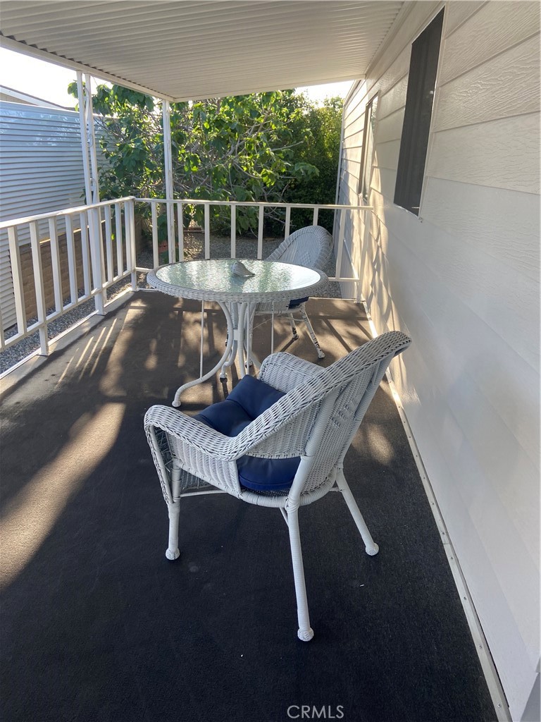 10210 Base Line Road Rancho Cucamonga, CA 91701 - Photo 8 of 13 a view of balcony with wooden floor and outdoor seating