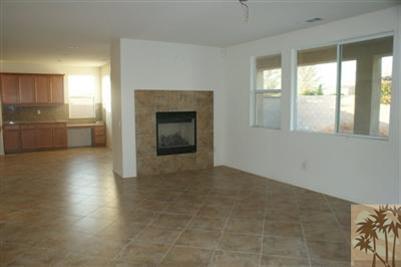 83384 Lone Star Road Indio, CA 92203 - Photo 4 of 20 an empty room with windows and fireplace