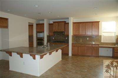 83384 Lone Star Road Indio, CA 92203 - Photo 5 of 20 a kitchen with stainless steel appliances granite countertop a sink and a stove