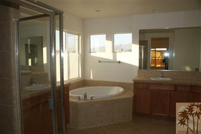 83384 Lone Star Road Indio, CA 92203 - Photo 8 of 20 a bathroom with a granite countertop sink and a mirror