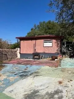 a view of a yard with wooden fence