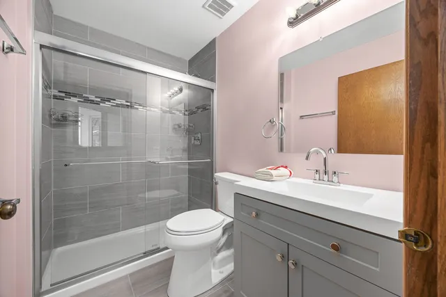 a bathroom with a sink mirror toilet and shower
