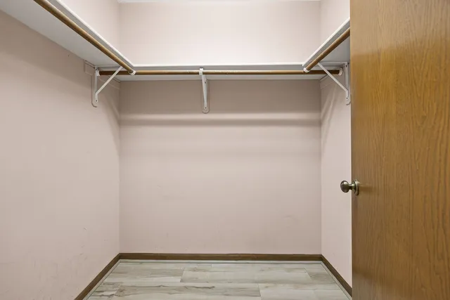 a bathroom with a granite countertop toilet a sink and a mirror