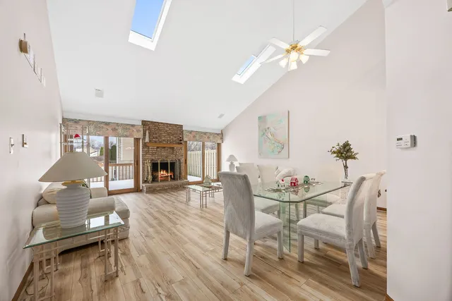 a living room with furniture a fireplace and a chandelier