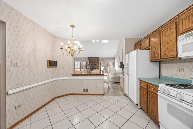 a kitchen with white cabinets and white appliances