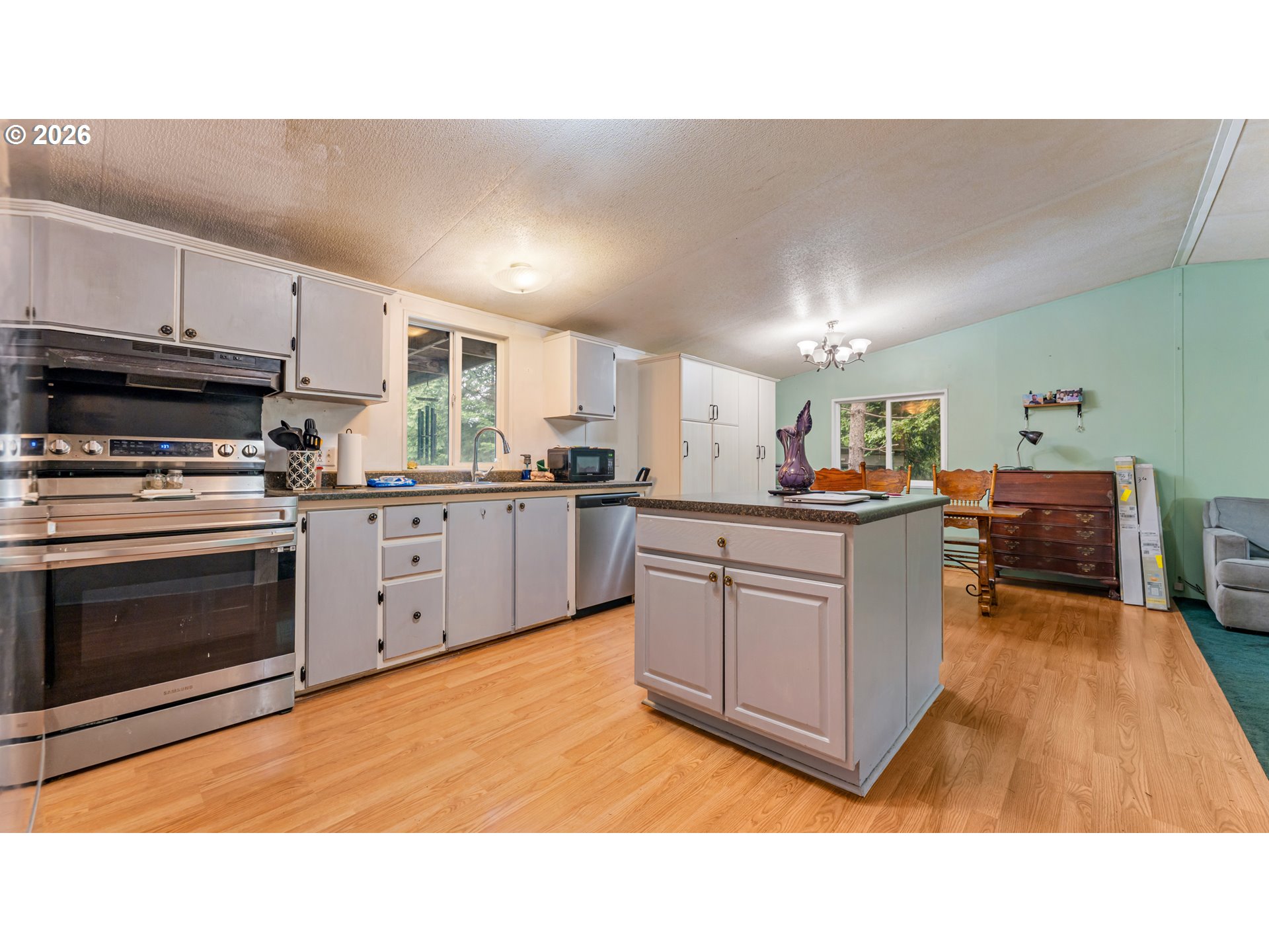 31484 Southeast Woodland Road Estacada, OR 97023 - Photo 6 of 40 a kitchen with sink cabinets and stainless steel appliances