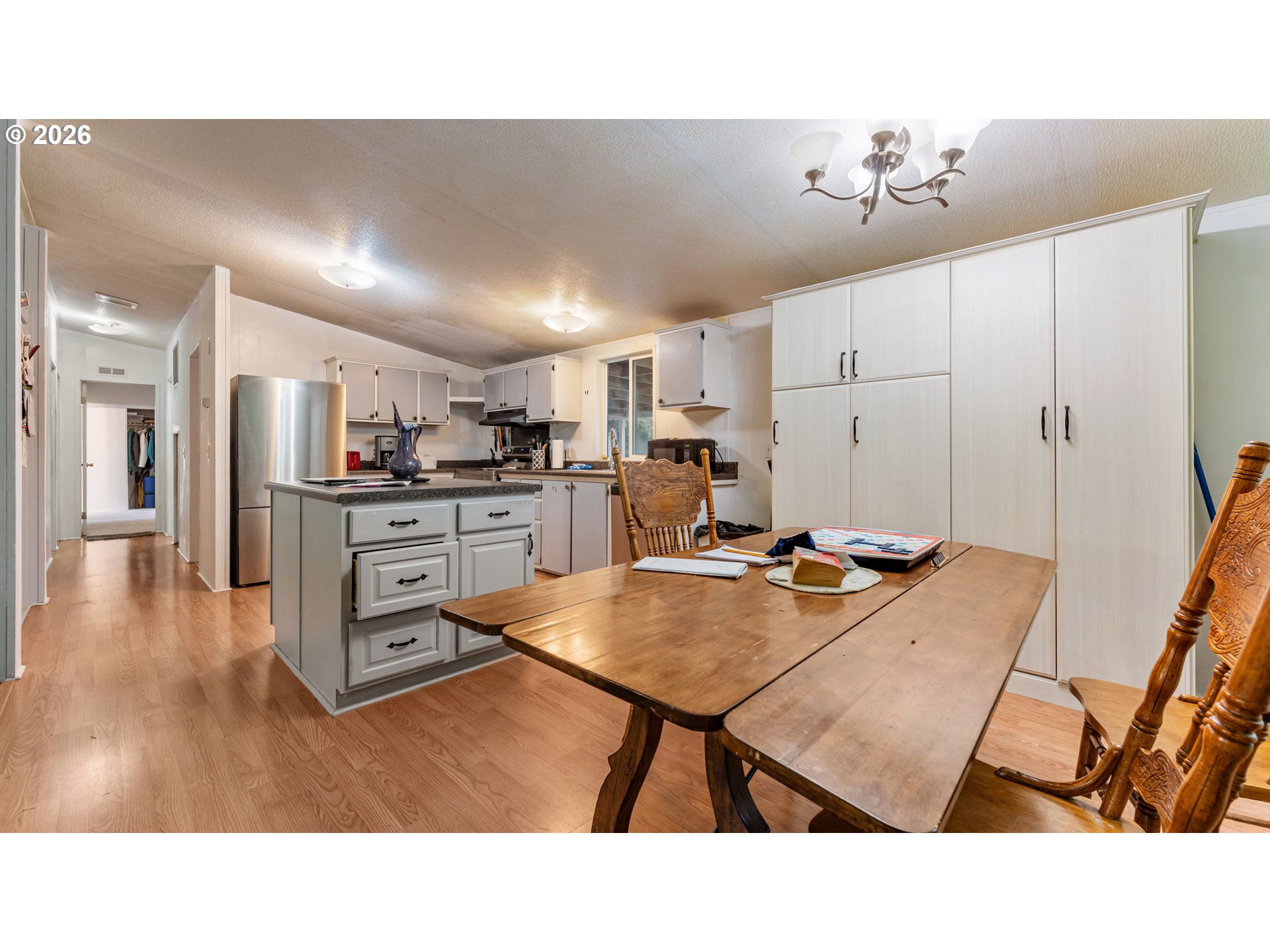 31484 Southeast Woodland Road Estacada, OR 97023 - Photo 7 of 40 a kitchen with kitchen island a stove a table and chairs