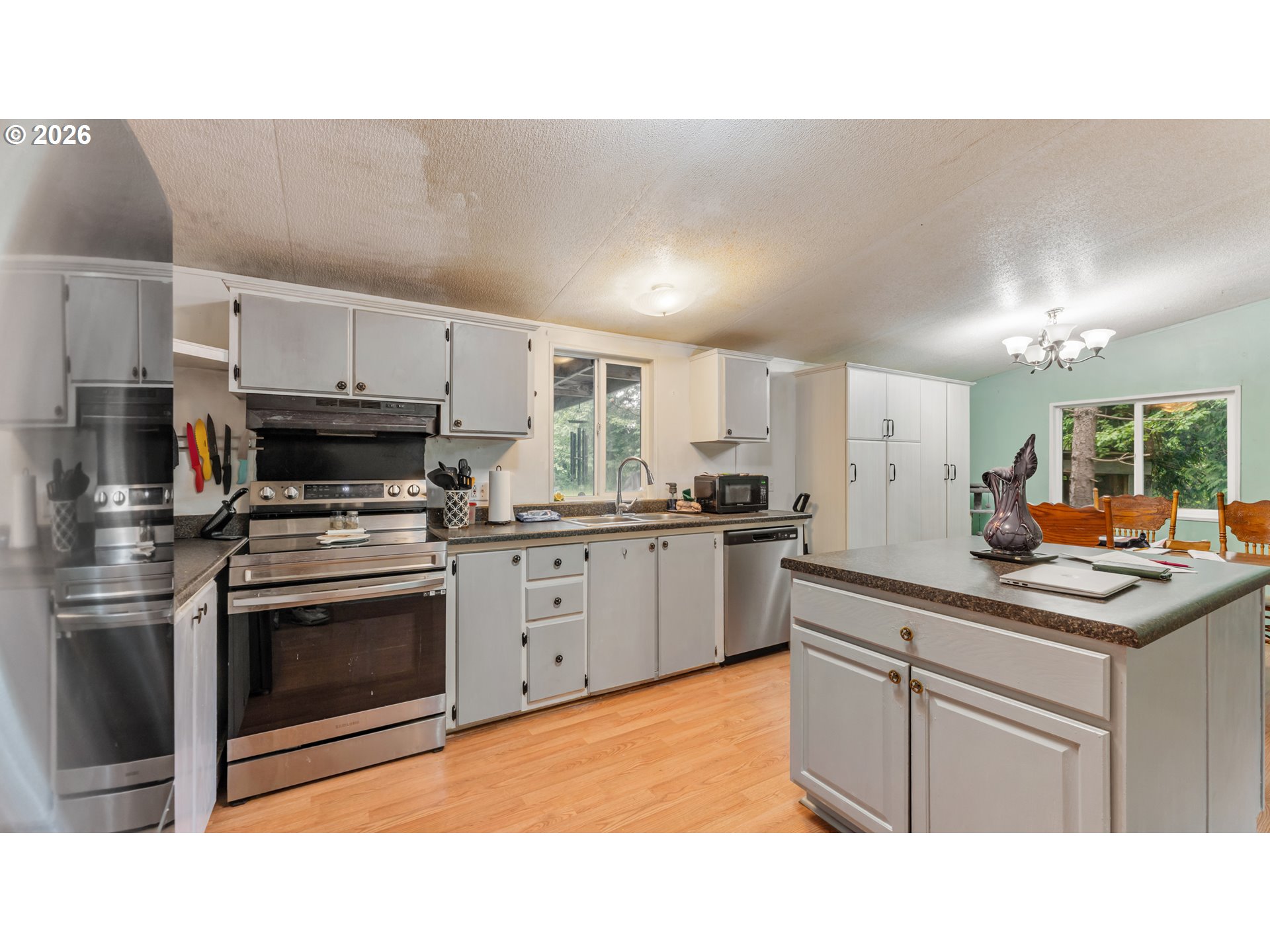 31484 Southeast Woodland Road Estacada, OR 97023 - Photo 10 of 40 a kitchen with stainless steel appliances a sink stove and cabinets