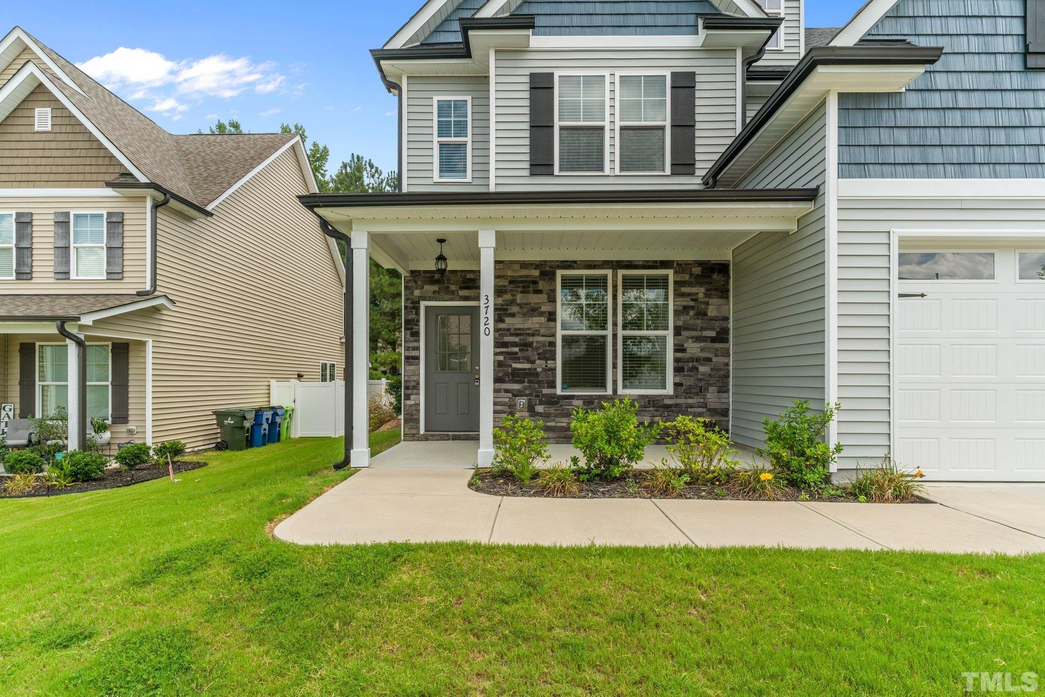 3720 Massey Ridge Court Raleigh, NC 27616 - Photo 6 of 56 a front view of a house with a yard and outdoor seating