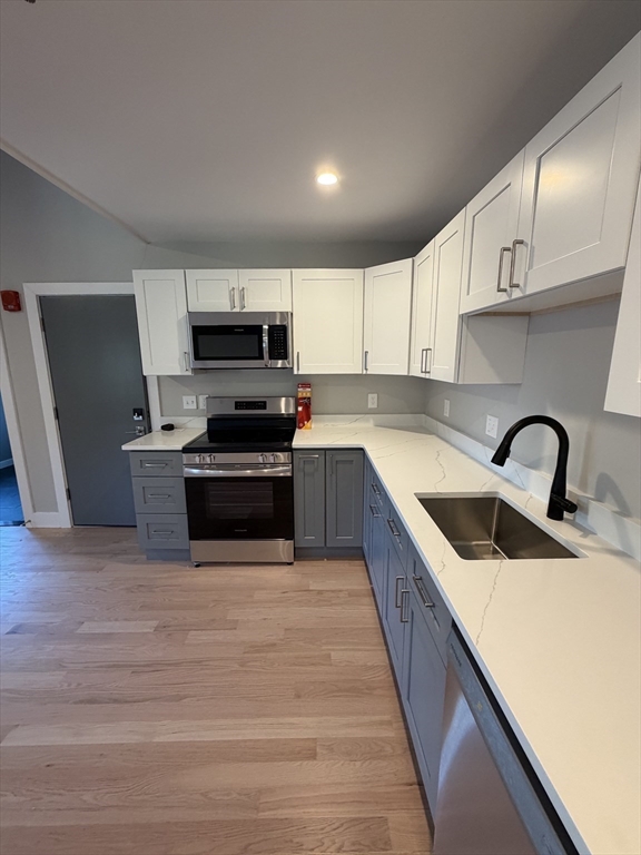 944 East Street, Unit 3 Walpole, MA 02081 - Photo 6 of 23 a kitchen with granite countertop a sink and steel appliances
