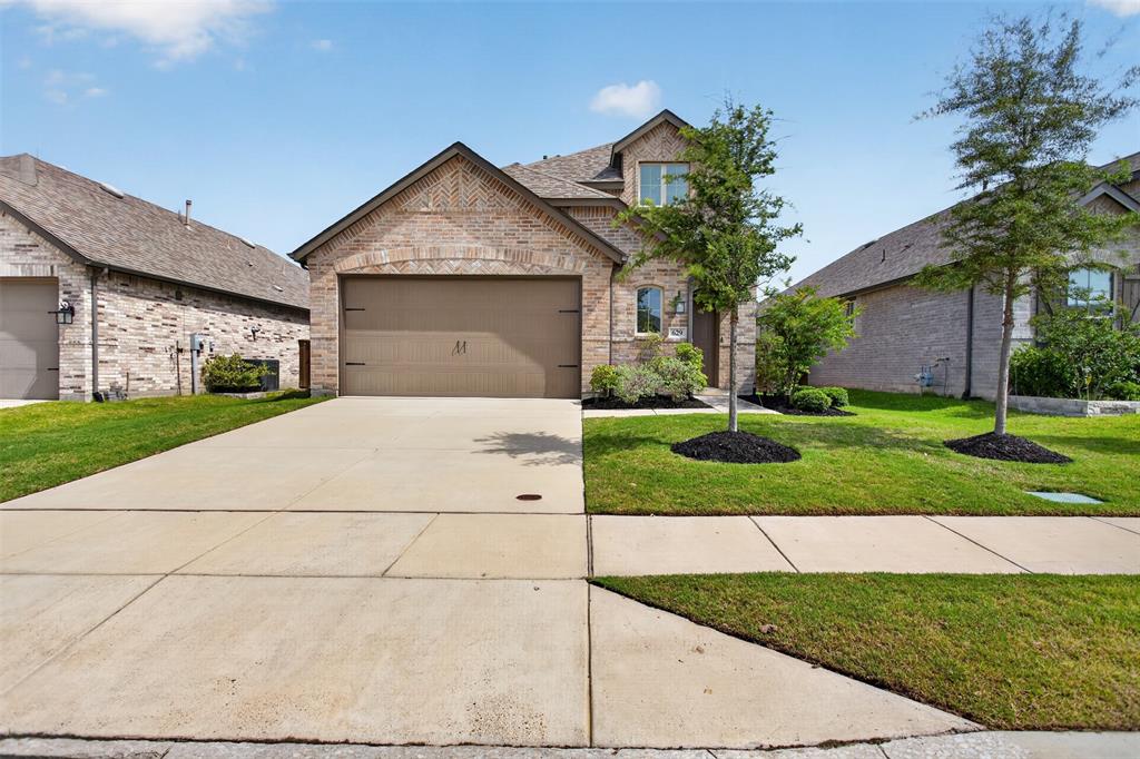 629 Claverton Lane Forney, TX 75126 - Photo 29 of 33 a front view of a house with a yard and garage