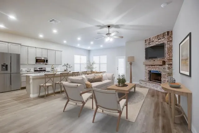 a kitchen with stainless steel appliances a refrigerator stove microwave and white cabinets