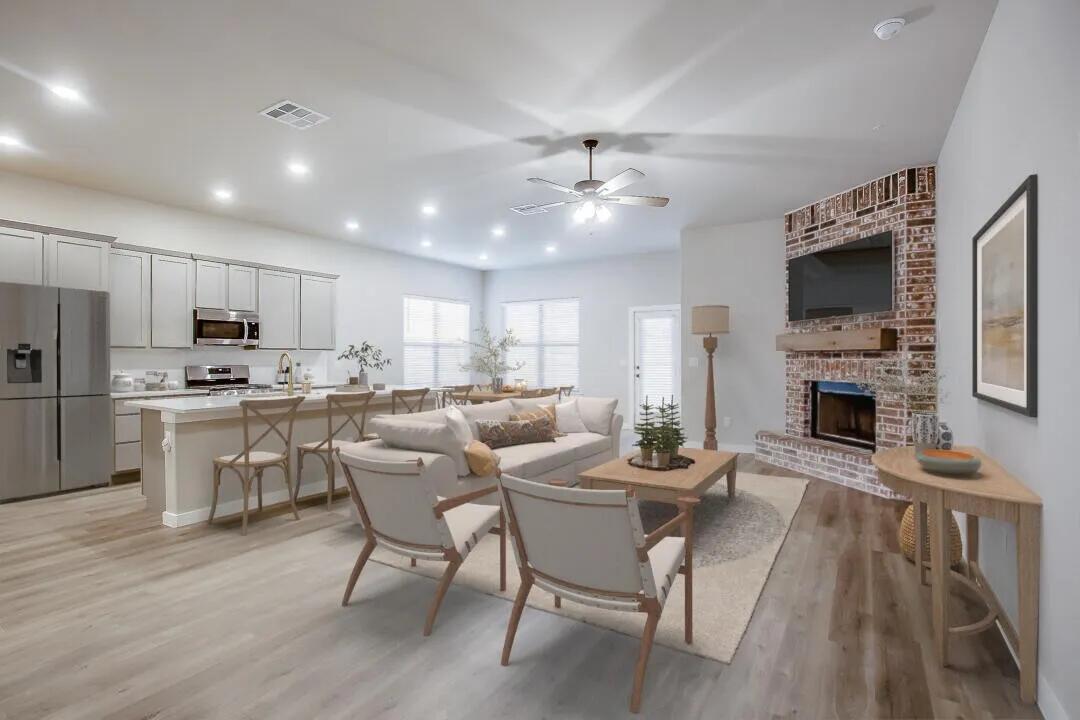 10502 Aberdeen Avenue Lubbock, TX 79424 - Photo 3 of 20 a dining room with stainless steel appliances kitchen island granite countertop furniture a fireplace a flat screen tv and kitchen view
