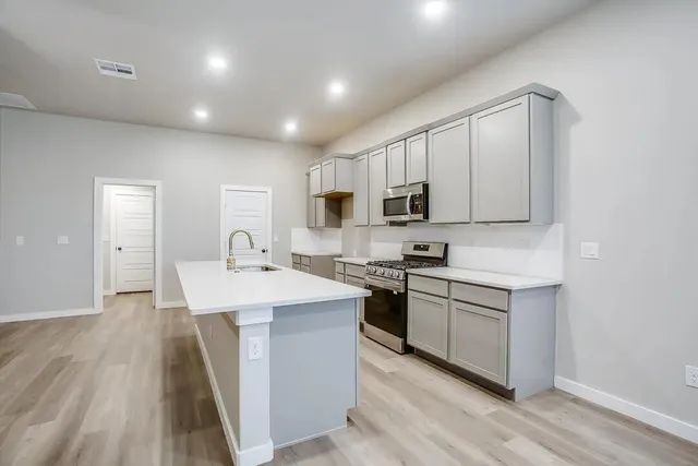 a bedroom with bed and a potted plant