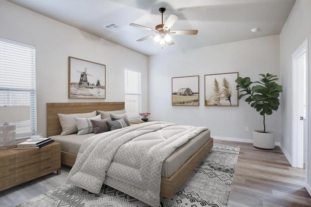 10502 Aberdeen Avenue Lubbock, TX 79424 - Photo 8 of 20 a bedroom with bed and a potted plant