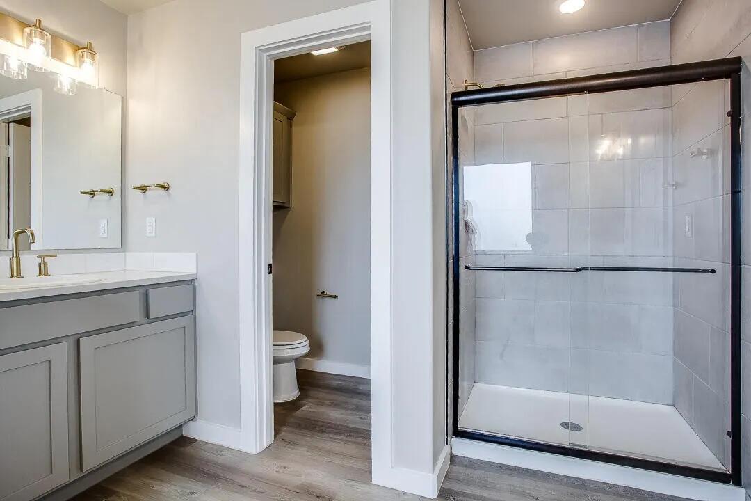 10502 Aberdeen Avenue Lubbock, TX 79424 - Photo 10 of 20 a bathroom with a shower a sink and a mirror