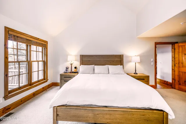 a bedroom with a bed and a lamp on table