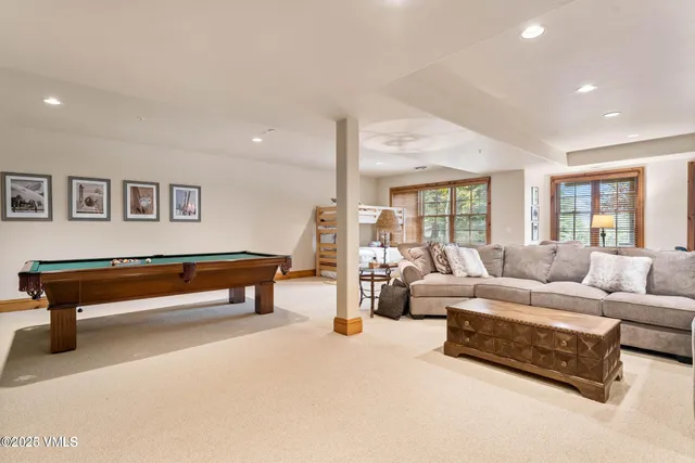 a balcony with wooden floor and outdoor seating