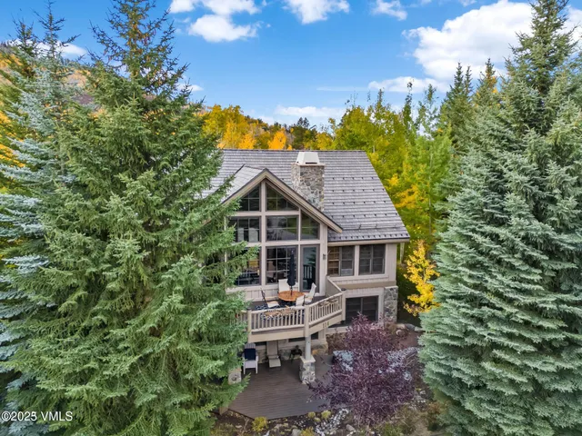 a living room with fireplace furniture and a large window