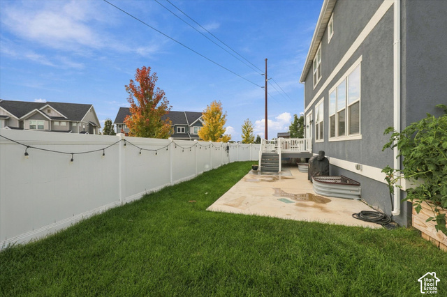 972 Vine Street Mapleton, UT 84664 - Photo 36 of 40 Private backyard featuring a concrete patio, white vinyl fencing, and a manicured lawn