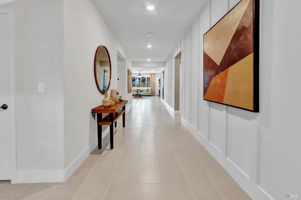 a view of a hallway with wooden floor and entryway