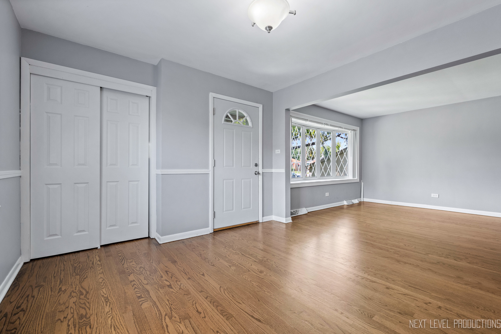 415 Clayton Road Hillside, IL 60162 - Photo 4 of 23 a view of an empty room with window and wooden floor