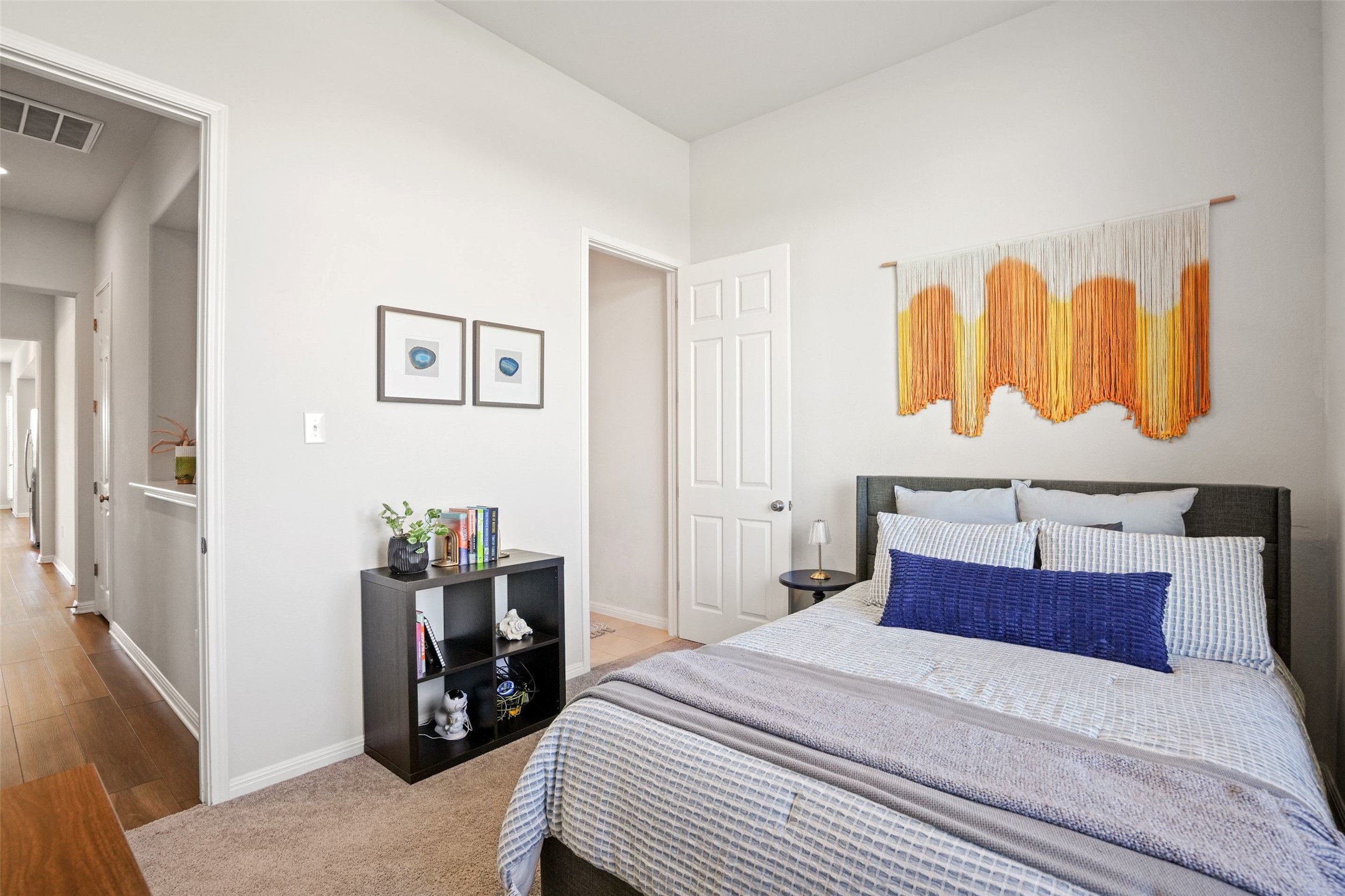 162 Lunar Loop Austin, TX 78737 - Photo 20 of 40 a bedroom with a bed and a lamp on dresser