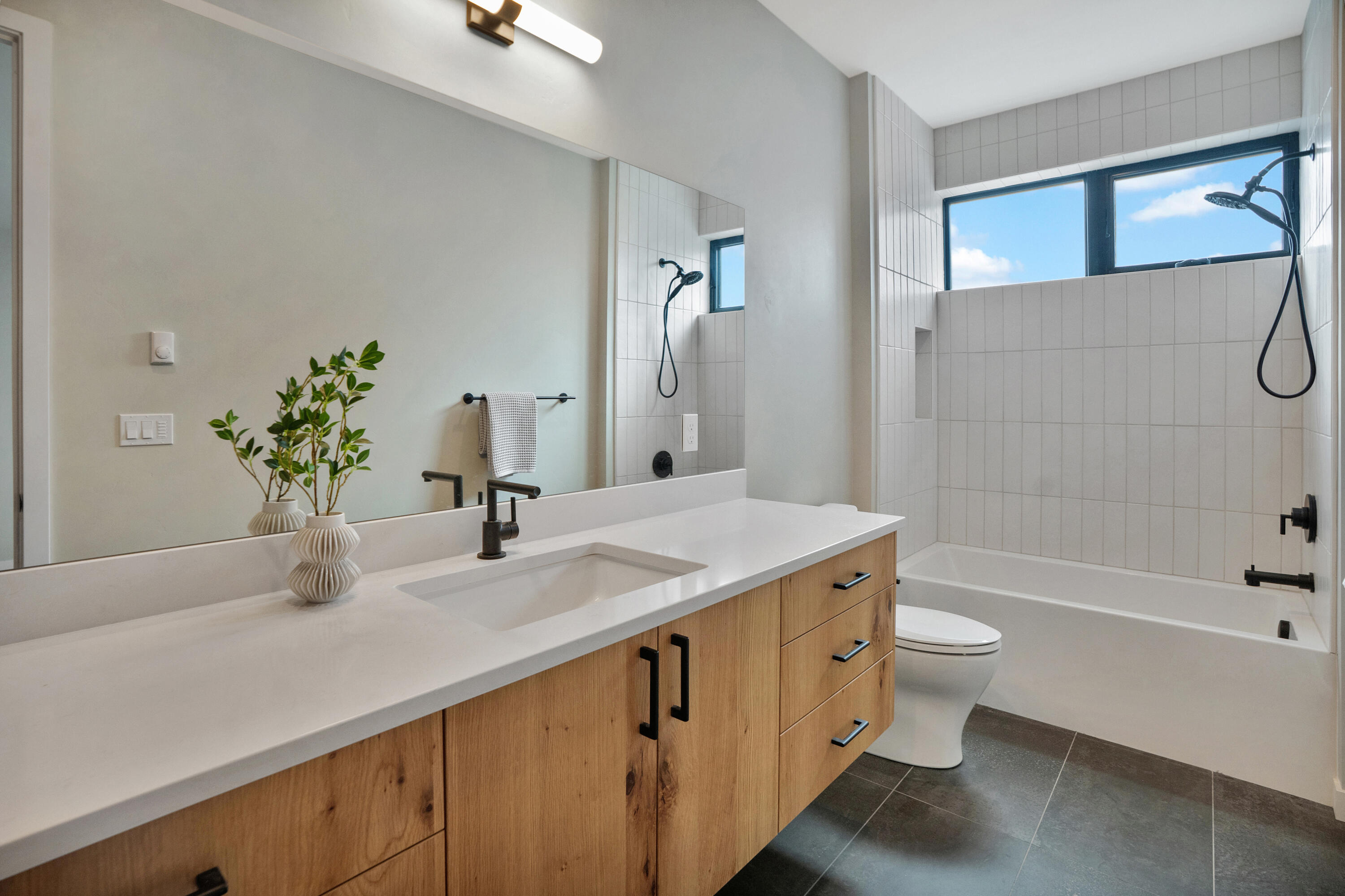 61250 Meeks Trail Bend, OR 97702 - Photo 33 of 43 a bathroom with a granite countertop sink a toilet and bathtub