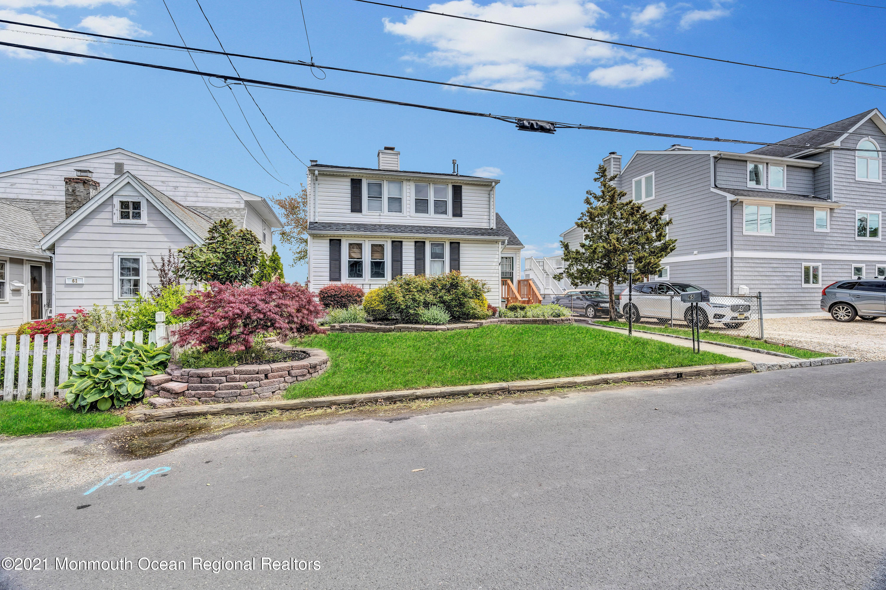 65 Metedeconk Road Brick, NJ 08723 - Photo 59 of 67 a front view of a house with a garden and plants