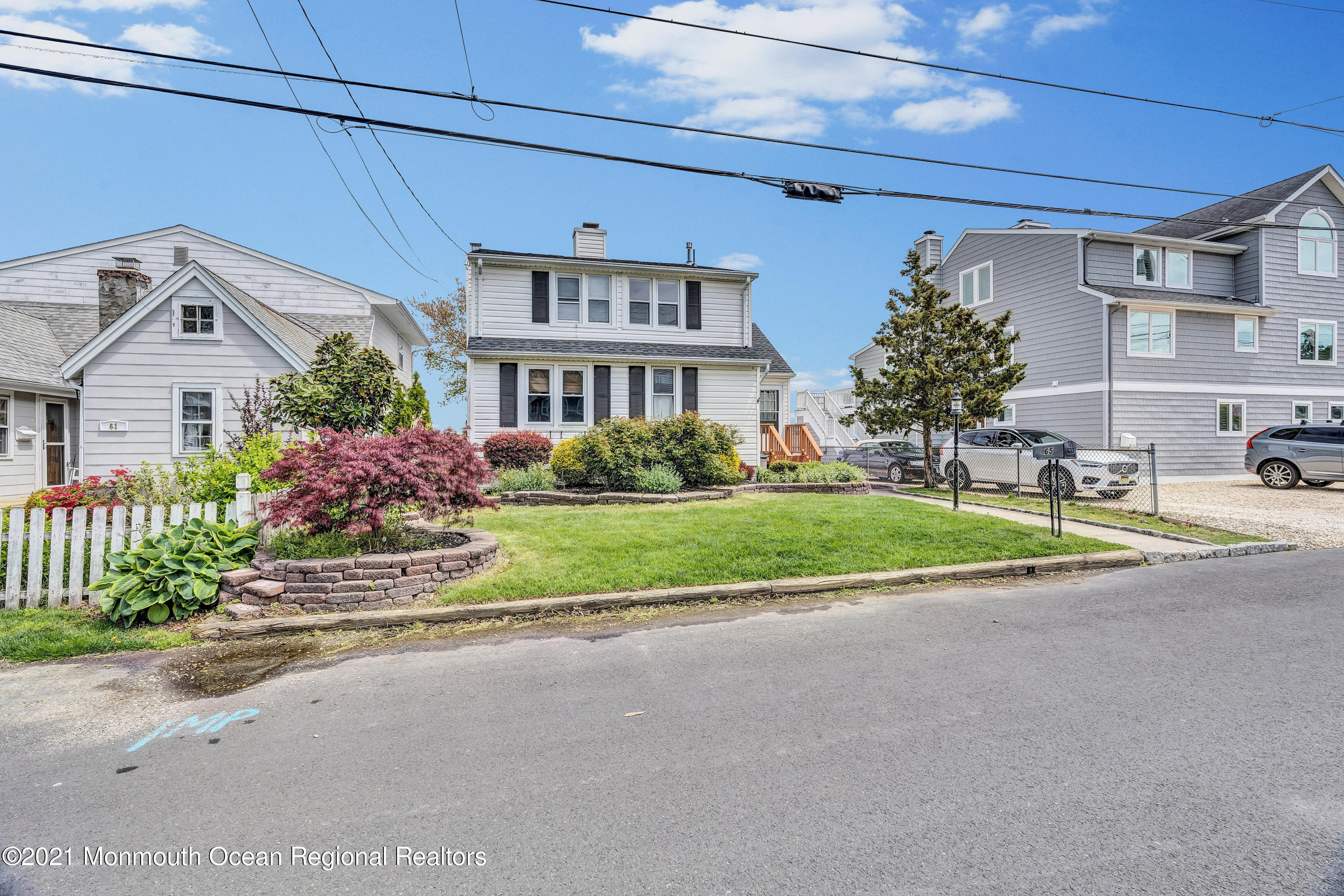 65 Metedeconk Road Brick, NJ 08723 - Photo 60 of 67 a front view of a house with a garden and plants