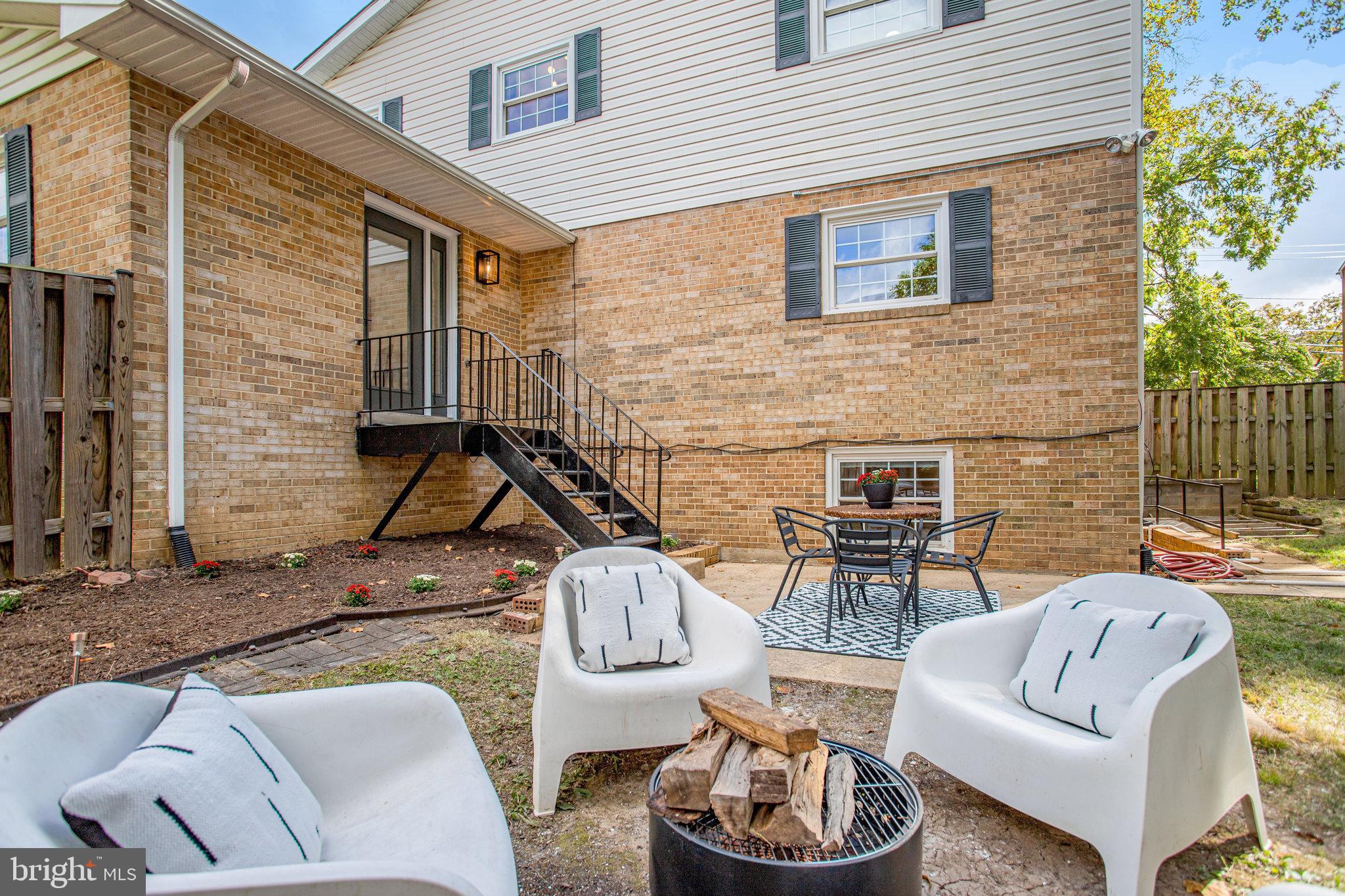 10915 Bucknell Drive, Unit 82 Silver Spring, MD 20902 - Photo 5 of 10 a backyard of a house with fire pit and outdoor seating